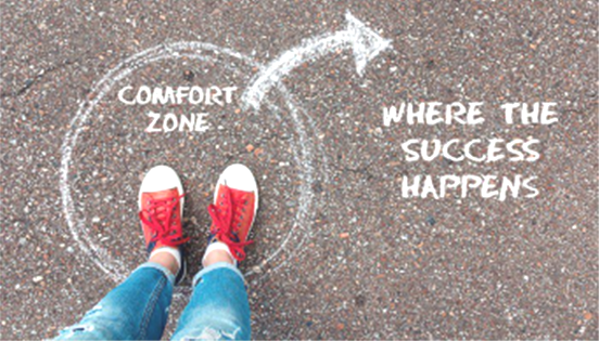 Feet in red sneakers inside a chalk circle labeled 'Comfort Zone' with an arrow to the text 'Where the success happens'—a motivational message about stepping out.