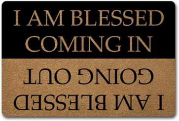 Two-tone sign with the phrase 'I am blessed coming in' shown upright on a black section and inverted on a brown section.